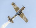 Aerobatic airplane pilot Jurgis Kairys training in the sky of the city. Colored airplane with trace smoke, airbandits, aeroshow