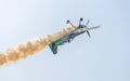 Aerobatic airplane pilot Jurgis Kairys training in the sky of the city. Colored airplane with trace smoke, airbandits, aeroshow