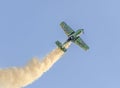 Aerobatic airplane pilot Jurgis Kairys training in the sky of the city. Colored airplane with trace smoke, airbandits, aeroshow