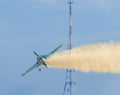 Aerobatic airplane pilot Jurgis Kairys training in the sky of the city. Colored airplane with trace smoke, airbandits, aeroshow