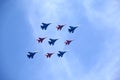 Aerobatic groups Russian Knights and Swifts on MIG-29 and SU-27 fighters in flight against blue sky Royalty Free Stock Photo