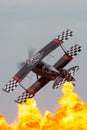Aerobatic pilot Skip Stewart flying his highly modified Pitts S-2S biplane Prometheus in front of the spectacular wall of fire pyr Royalty Free Stock Photo