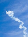 Aerobatic plane performing a multiple corkscrew maneuver leaving a smoke trail Royalty Free Stock Photo