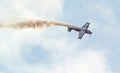 Aerobatic plane. Smoke trail as it does stunts. Royalty Free Stock Photo