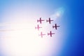 Aerobatic team group of fighters jet aircraft fly against the bright sun leaving a smoky trail in the air Royalty Free Stock Photo