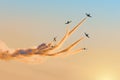 The aerobatic team of light fighters dissolves in the evening sky, leaving a smoky trail Royalty Free Stock Photo