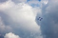 Aerobatic team Russian Knights at air show. Cloudy sky in the ba