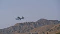 Aerobatics. Multipurpose seaplane Be-6. Flying over the mountains against the blue sky.