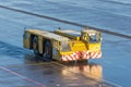 Aerodrome tow tractor is driving along the steering paths at the airport