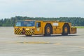 The aerodrome tractor is driving along the steering paths at the airport.