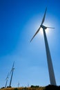 Aerogenerator windmills in a row in blue sky