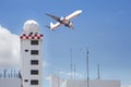 Aeronautical meteorological station tower or weather radar dome station tower in airport with passenger airplane jet taking off Royalty Free Stock Photo