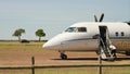 Aeroplane, airplane landing on dirt runway for small prop planes with propellors in Masai Mara North