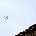 Aeroplane flying in the cloudy sky during the day time near Qutub Minar in Delhi India, Aeroplane flying high in the sky