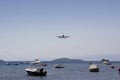Aeroplane flying in over Skiathos old harbour, Skiathos Town, Greece, August 18, 2017 Royalty Free Stock Photo