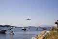 Aeroplane flying in over Skiathos old harbour, Skiathos Town, Greece, August 18, 2017 Royalty Free Stock Photo