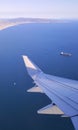 Aerial view over the Pacific Ocean and the Californian coast with a cargo ship