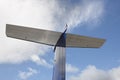 Aeroplane wing tale viewed from below with blue sky Royalty Free Stock Photo