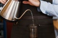 Aeropress coffee alternative making by barista in the cafe. Scandinavian coffee brewing method. Barista pours water to