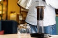 Aeropress coffee close up alternative making by barista in the cafe. Scandinavian coffee brewing method. Barista pours