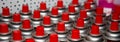 Aerosol cans with a bright red lid are in a row. Macro photo. Selective focus on the nozzle. paint Royalty Free Stock Photo