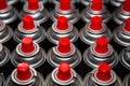 Aerosol cans with a bright red lid are in a row. Macro photo. Selective focus on the nozzle. paint Royalty Free Stock Photo