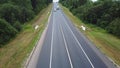 Aerovideo trucks and cars driving along the highway along the forest