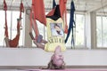 Aeroyoga. The child is engaged in anti-gravity yoga. Hangs upside down