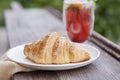 Aesthetic breakfast - french traditional croissant with refreshment strawberry mojito cocktail outside. Selective focus.