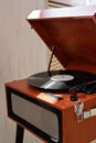 Aesthetic brown wooden retro digital vinyl player, turntable with vinyl record in sunlight with dust, nostalgic music Royalty Free Stock Photo