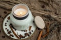 Aesthetic composition of candles, anise, cinnamon sticks and coffee beans on a background of burlap Royalty Free Stock Photo