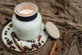 Aesthetic composition of candles, anise, cinnamon sticks and coffee beans on a background of burlap Royalty Free Stock Photo