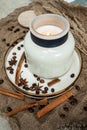 Aesthetic composition of candles, anise, cinnamon sticks and coffee beans on a background of burlap Royalty Free Stock Photo