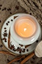 Aesthetic composition of candles, anise, cinnamon sticks and coffee beans on a background of burlap Royalty Free Stock Photo