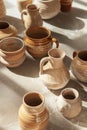 Aesthetic composition of craft hand-made clay products such as vases, jugs, cups in assortments. Top view Royalty Free Stock Photo