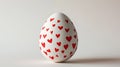 Aesthetic Easter white egg painted with red hearts. White background. Copy space. Generative AI