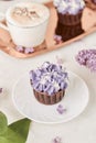 Aesthetic french purple floral cupcakes using trend Dreamy Escapism. Leisure and relax coffee time