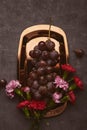 Aesthetic grapes with aster flower on the golden tray. Summertime seasonal background