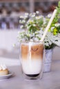 Aesthetic iced latte in the cafe. Guilty pleasure, coffee time. Vertical photo