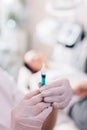 Aesthetic medicine doctor preparing syringe for injection Royalty Free Stock Photo