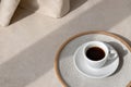 Aesthetic neutral background with coffy cup on beige stone table with sun light shadow, minimalist summer background, copy space