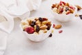 Aesthetic saucers with mixed nuts close up. Hazelnuts, cashew, raisins, cranberries, walnuts, almonds. Healthy food and Royalty Free Stock Photo