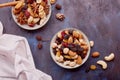 Aesthetic saucers with mixed nuts close up. Walnuts, almonds, hazelnuts and cashews, raisins and cranberries on rustic Royalty Free Stock Photo