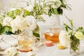 Aesthetic tea time, herbal tea and macaron desserts in biophilic interior among white flowers. Natural herbal tea -