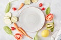 Aesthetic, vegan, organic, healthy food, plant-based diet concept. White plate on the table among vegetables and fruits Royalty Free Stock Photo