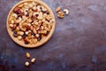 Aesthetic wooden bowl with assorted nuts, raisins and cranberries from above on rustic background. Hazelnuts , walnuts Royalty Free Stock Photo