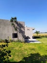 Aesthetically built luxury villa and it's green lawn in the winter afternoon sunlight