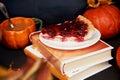 Aesthetics cozy home - autumn cup of coffee in shape of pumpkin, cherry pie and books. Atmospheric cozy coffee time