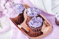 Aesthetics purple floral cupcakes. No sugar sweet dessert among lilac.