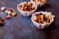 Aesthetics saucers with mixed nuts close up. Almonds, walnuts, hazelnuts and cashews. Raisins and cranberries. Healthy Royalty Free Stock Photo